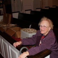 Mildred Witten supervises the decorating of the tree.